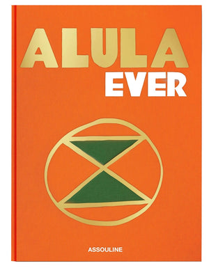 Orange book titled "AlUla Ever" with gold and green geometric designs on the cover, highlighting AlUla, a UNESCO World Heritage Site in Saudi Arabia. The publisher's name "Assouline" appears at the bottom.