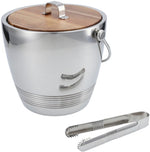 The Fortessa Crafthouse Classic Round Ice Bucket with Tongs features a stainless steel body, elegant acacia lid, side handle, and metal tongs placed in front.