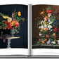 An open book exhibiting two pages with vibrant botanical illustration still-life paintings from Flowers: Art & Bouquets by Assouline on a dark background.