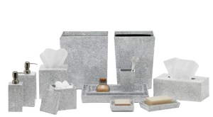The Pigeon & Poodle Callas Bath Collection features silver speckled bathroom accessories—tissue box, soap dispenser, tray, sanitizer bottle, and wastebasket—all elegantly arranged with a mosaic touch.