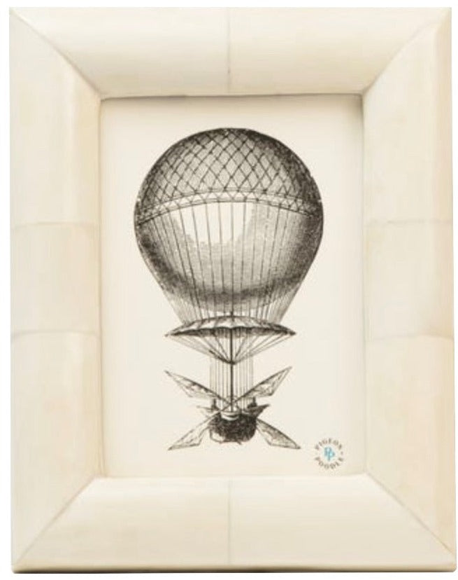 Black and white illustration of a vintage hot air balloon in a thick, beveled bone Vannes Frame from Pigeon & Poodle—an elegant addition to any curated collection.