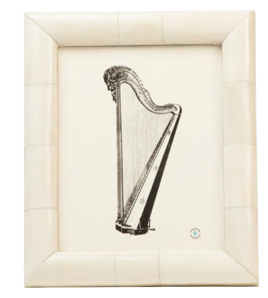 A sophisticated black and white harp illustration from the Vannes Frame Collection by Pigeon & Poodle, elegantly displayed in a beveled, ivory-toned frame—ideal for refined décor.