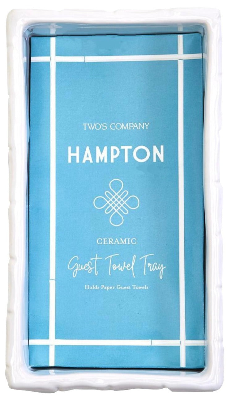 The Hampton Faux Bamboo Fretwork Guest Towel Tray by Two's Company is a white rectangular holder with faux bamboo detailing, perfect for displaying a stack of paper guest towels in elegant Chinoiserie-inspired style.