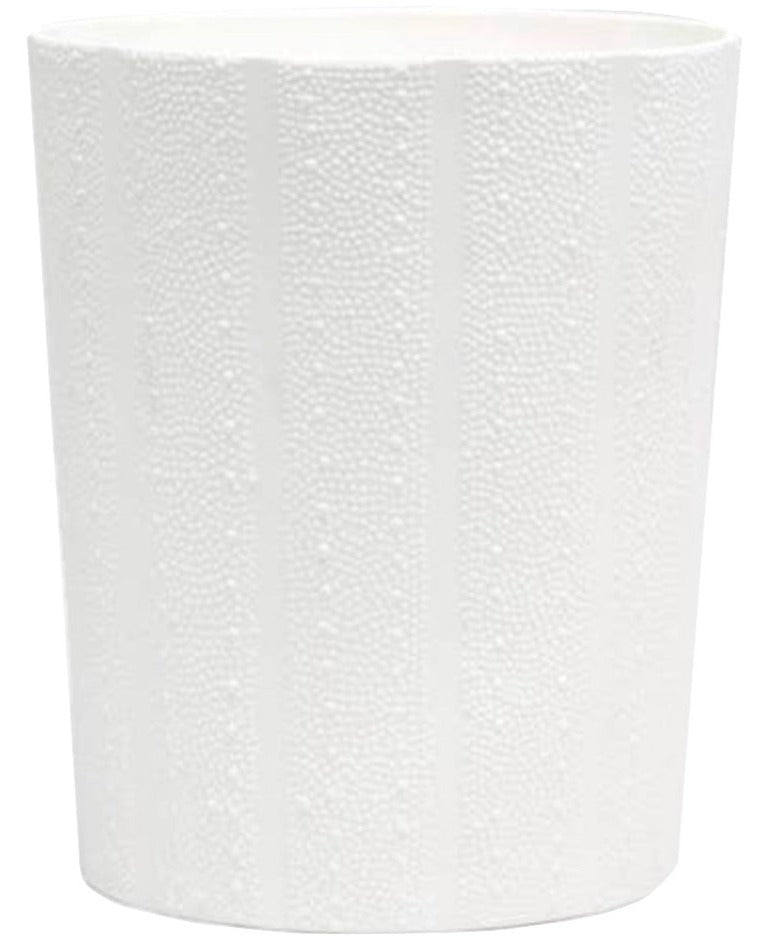 The Hilo Bath Collection by Pigeon & Poodle features a white cylindrical porcelain planter with subtle vertical stripes, a matte finish, and a design inspired by delicate sea urchin patterns.