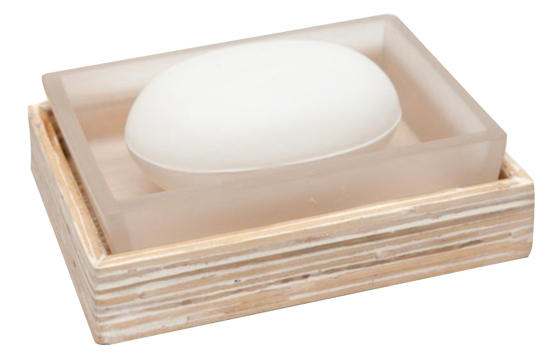A white bar of soap rests in a frosted dish atop a striped wooden tray from the Pigeon & Poodle Kona Bath Collection, capturing the relaxed elegance of island life.