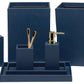 The Dannes Bath Collection by Pigeon & Poodle features navy blue bathroom accessories in faux waxed Belgian linen, including a tissue box, soap dish, tray, toothbrush holder, soap dispenser, waste bin, and storage containers.