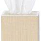 A tissue box from Pigeon & Poodle’s Maranello Bath Collection features a light wood texture with a white tissue partially visible at the top.