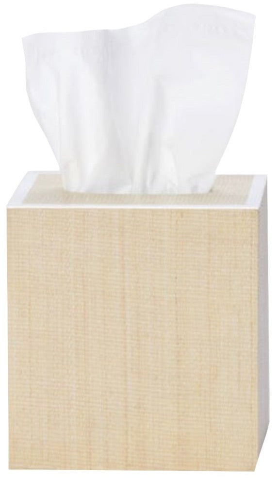 A tissue box from Pigeon & Poodle’s Maranello Bath Collection features a light wood texture with a white tissue partially visible at the top.
