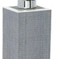 A rectangular gray soap dispenser from Pigeon & Poodle's Maranello Bath Collection features a textured abaca-resin–like surface and a shiny silver pump.