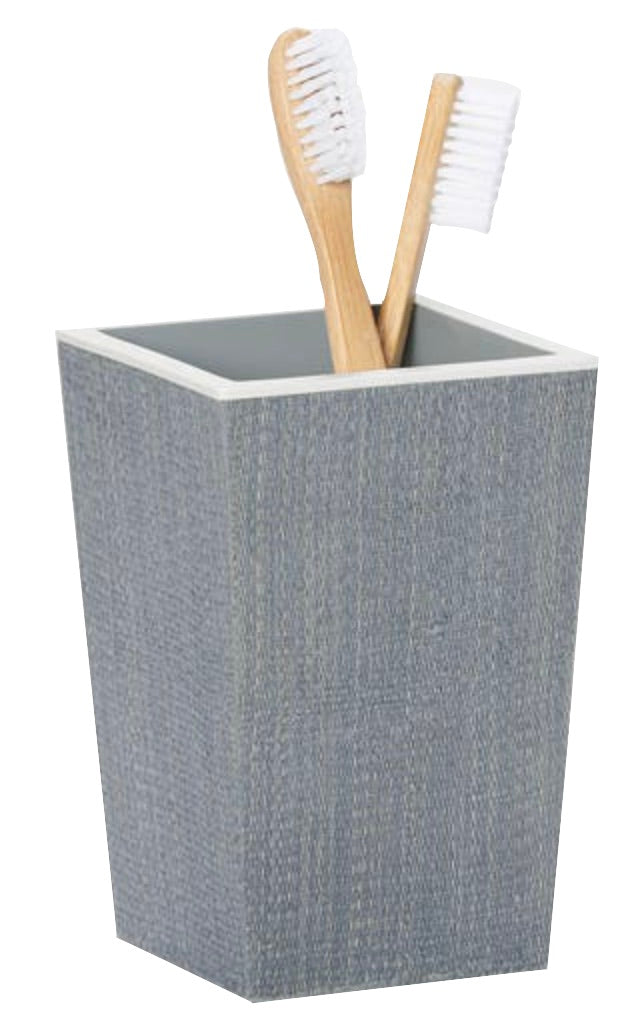 A grey textured cup from the Pigeon & Poodle Maranello Bath Collection holds two wooden-handled toothbrushes with white bristles.