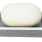 A white soap bar rests on a rectangular gray Maranello Bath Collection dish by Pigeon & Poodle, featuring a white rim and durable abaca-resin construction for lasting style.