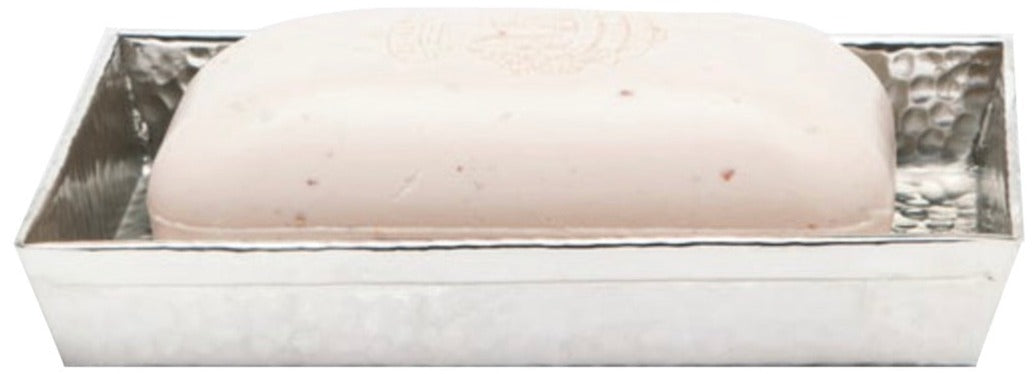 A light-hued rectangular soap sits in a hand-hammered silver dish from Pigeon & Poodle’s Verum Bath Collection, bringing artisanal elegance to your bathroom.