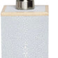 The Manchester Bath Collection by Pigeon & Poodle features a rectangular soap or lotion dispenser with a textured white shagreen body and a metallic pump top.