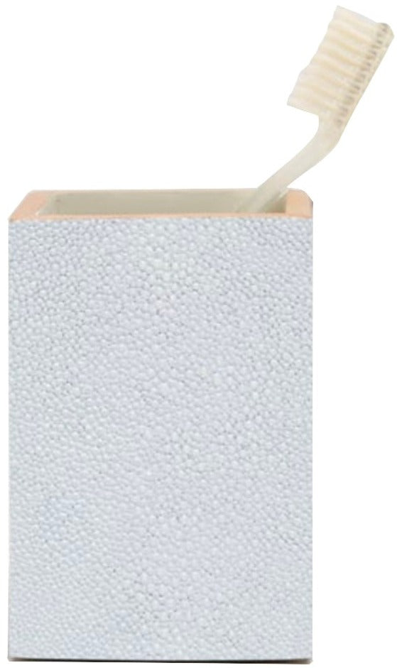 A white toothbrush rests in the Manchester Bath Collection holder by Pigeon & Poodle, which features a rectangular shape and elegant shagreen texture.