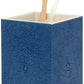 The Manchester Bath Collection by Pigeon & Poodle features a blue shagreen-textured toothbrush holder with two toothbrushes—one with a wooden handle and one with a clear handle.