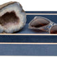 A pair of sunglasses and a geode are displayed on nested blue rectangular trays with beige trim from the Manchester Bath Collection by Pigeon & Poodle.
