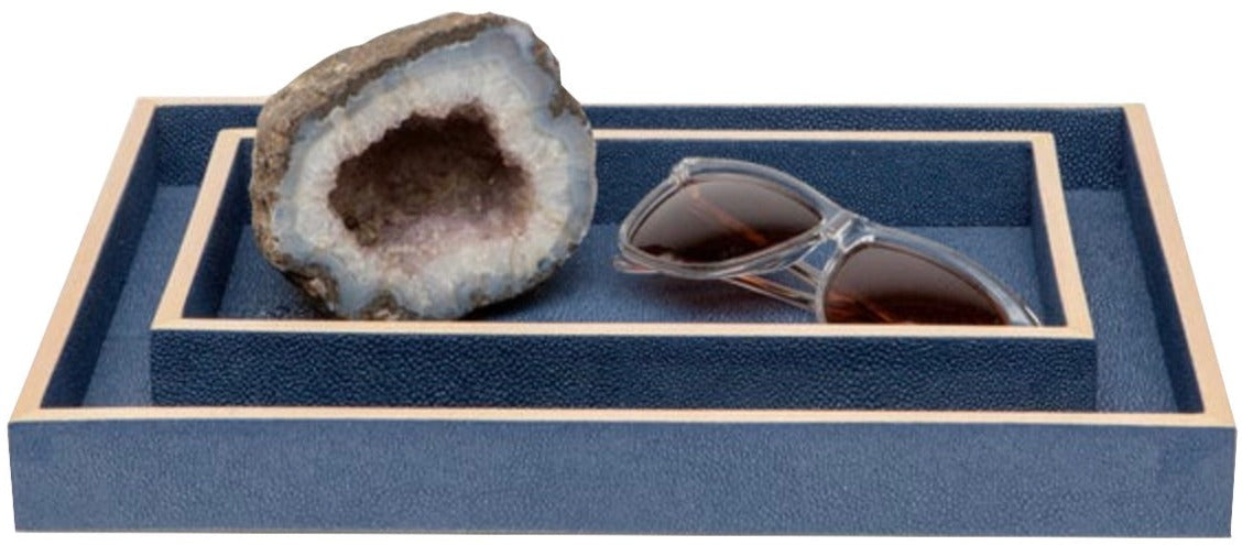 A pair of sunglasses and a geode are displayed on nested blue rectangular trays with beige trim from the Manchester Bath Collection by Pigeon & Poodle.