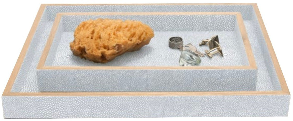 The Manchester Bath Collection by Pigeon & Poodle features three stacked rectangular trays with veneer trim, shown holding a natural sponge, ring, glass pebble, and cufflinks.