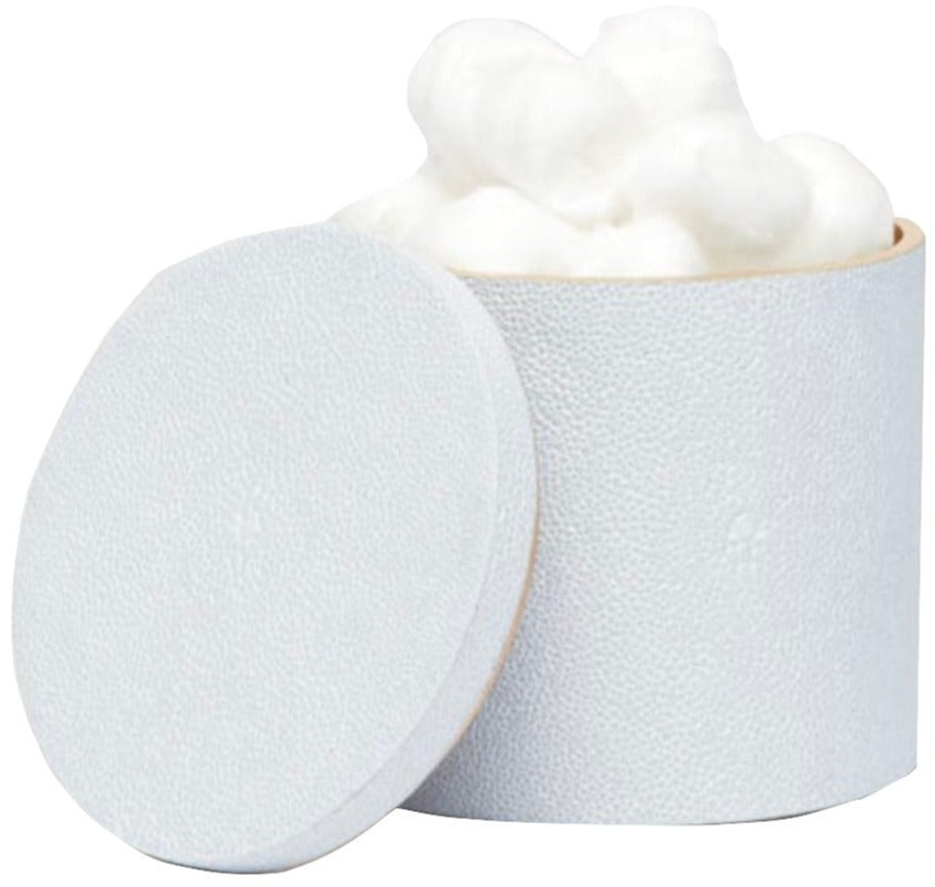 A round, textured white container from the Manchester Bath Collection by Pigeon & Poodle sits with its lid off, revealing white cotton balls inside and showcasing a subtle shagreen finish.