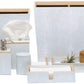 The Manchester Bath Collection by Pigeon & Poodle includes tissue boxes, soap dispensers, waste bins, trays, jars, a glass, and a bottle—all in light blue with wood details and elegant veneer trim.