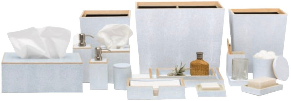 The Manchester Bath Collection by Pigeon & Poodle includes tissue boxes, soap dispensers, waste bins, trays, jars, a glass, and a bottle—all in light blue with wood details and elegant veneer trim.