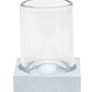 A clear glass sits upright on a textured, square, light-colored coaster from the Manchester Bath Collection by Pigeon & Poodle, set against a white background.