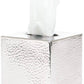 The Verum Bath Collection by Pigeon & Poodle features a hand-hammered silver tissue box with a textured finish and crisp white tissue visible at the top.