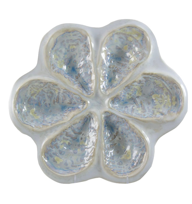The Oyster Platter Collection by AE Ceramics features a glossy light blue and white ceramic platter with six petal-shaped sections in a flower pattern—ideal for serving oysters Rockefeller or oysters on the half shell.
