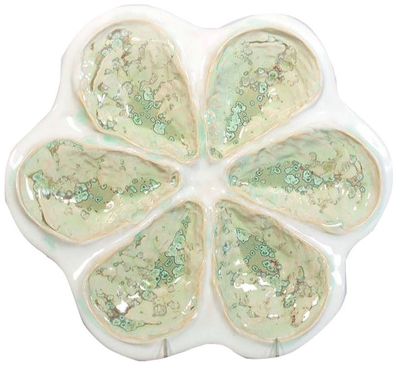 The AE Ceramics Oyster Platter Collection features six petal-shaped sections with a glossy marbled green and beige glaze, perfect for elegantly serving Oysters Rockefeller or oysters on the half shell.