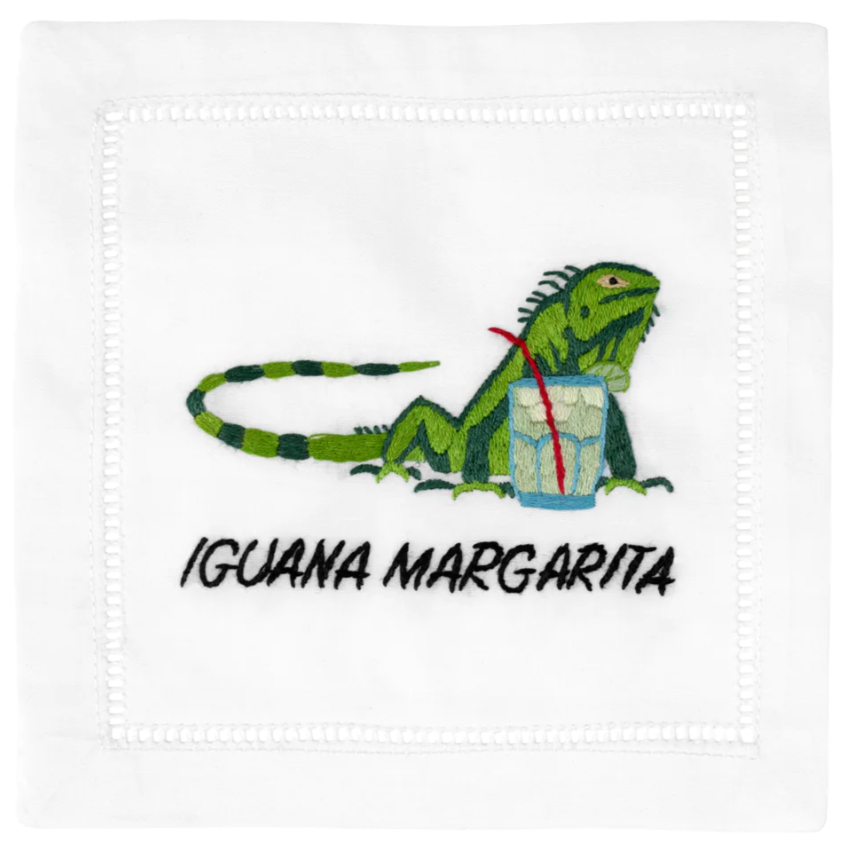 The August Morgan Cocktail Napkins "Iguana Margarita" features an elegant cotton design with a green iguana next to a glass, labeled "Iguana Margarita," perfect for a chic margarita napkin set.
