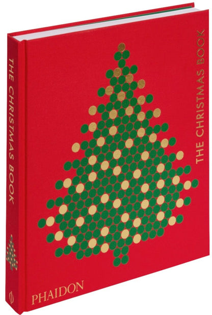 The red Phaidon book titled "The Christmas Book" showcases a cover with a geometric tree design made of green and gold dots, capturing the spirit of beloved holiday traditions.