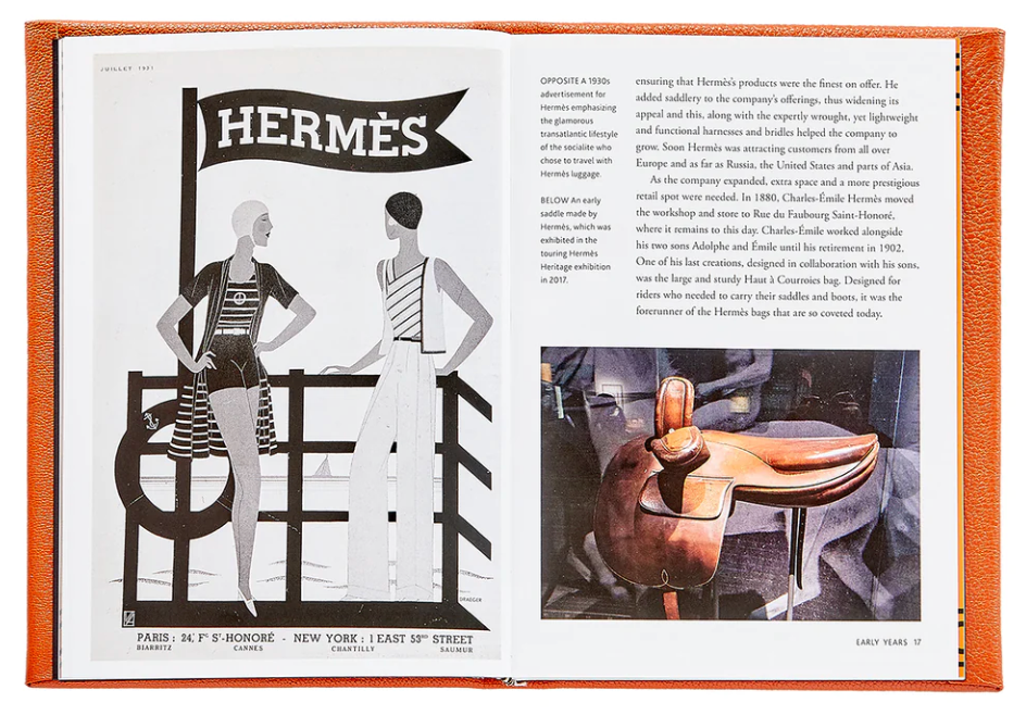 The open book reveals a vintage Hermès advertisement on the left and a text passage accompanied by an image of a horse sculpture on the right. Ideal for any fashion historian, the Little Book of Hermès by Graphic Image, with its distinctive orange cover, stands out against the white background, embodying the essence of timeless luxury accessories.