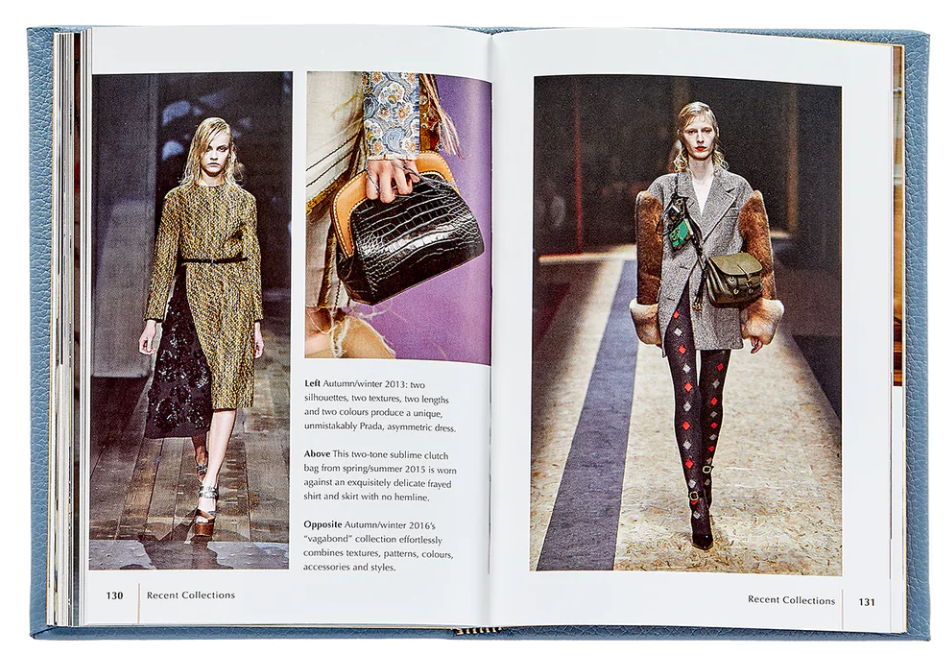 An open Little Book of Prada displaying two pages, each featuring a model wearing designer outfits from Graphic Image's autumn/winter collections, with text annotations highlighting the design elements and year of the collections.