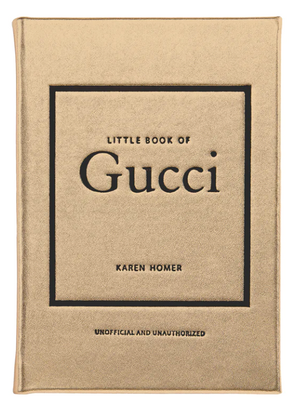 The cover of the "Little Book of Gucci" by Karen Homer, produced by Graphic Image, boasts a gold background with black text, beautifully encapsulating Gucci's opulent fashion heritage and Italian elegance.