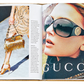 The *Little Book of Gucci* by Graphic Image presents a stunning display of Gucci fashion: the left page features a model adorned with a fringed bag and gold heels, while the right page provides an up-close view of a woman wearing large sunglasses next to the iconic Gucci logo, celebrating Italian luxury and its rich fashion history.