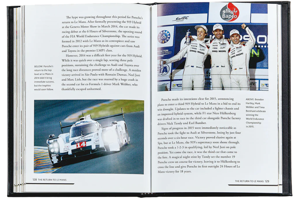 An open book titled "The Story Of Porsche Black Leather" by Graphic Image features a race car and drivers in uniform. It narrates Porsche's return to top-level racing, highlighting the luxury and innovation of its LMP1 hybrid vehicle with style and speed.