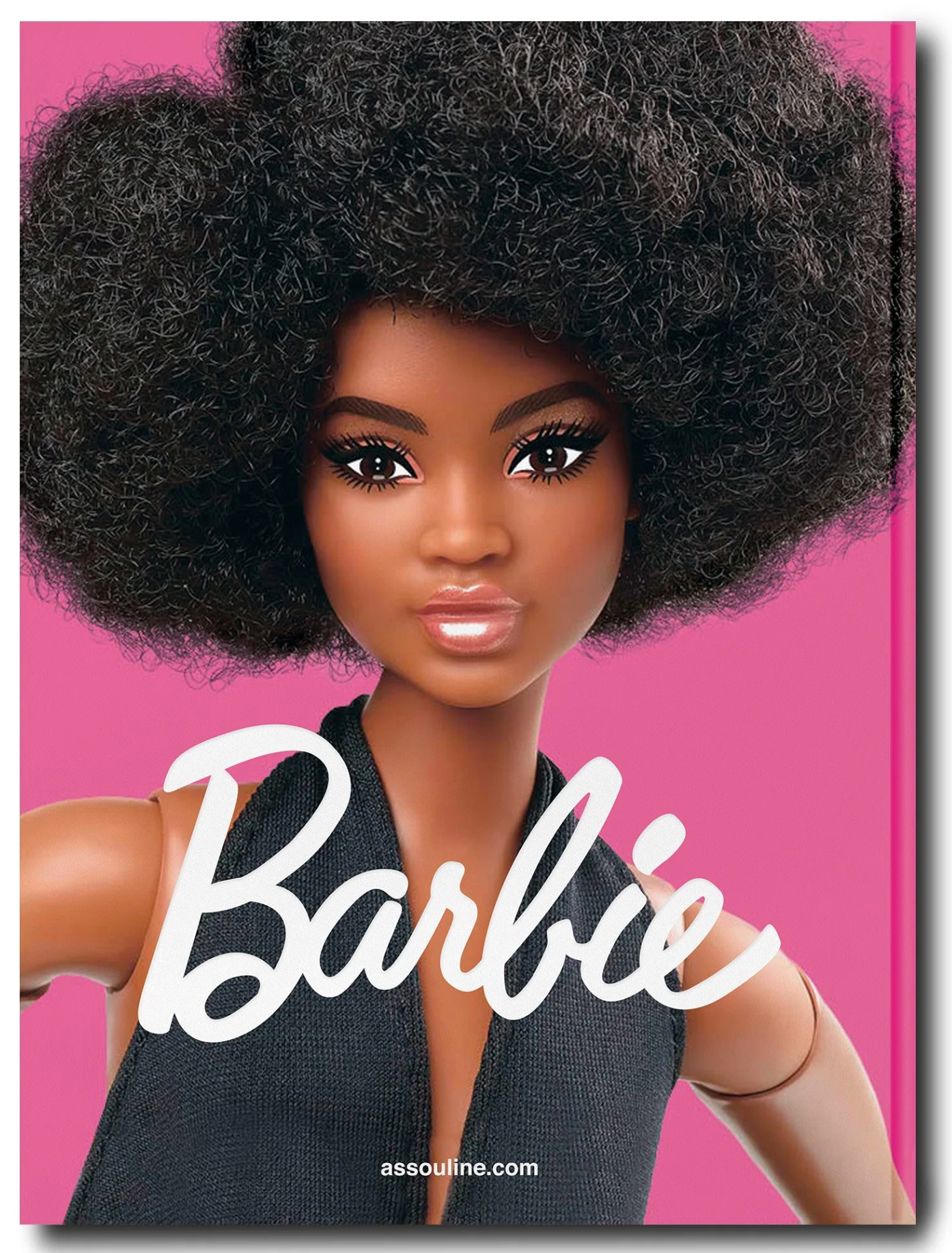 Assouline Barbie doll with an afro hairstyle against a pink background, showcasing Barbie's journey as a feminist visionary.