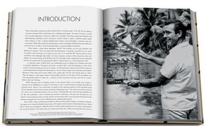 An open book featuring an image of a man holding a camera capturing iconic places, such as James Bond Destinations by Assouline.