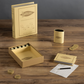 The WS Game Company Yahtzee Vintage Bookshelf Edition, showcased on a wooden surface, encompasses a book-like box, deluxe rolling tray, dice, scorecards, cup, and poker-style YAHTZEE chips.