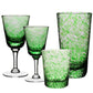 Four glass pieces from the William Yeoward Crystal Vanessa Green Collection—two stemmed wine glasses and two tumblers—are arranged on a white background, their textured surfaces creating a subtle optical illusion.