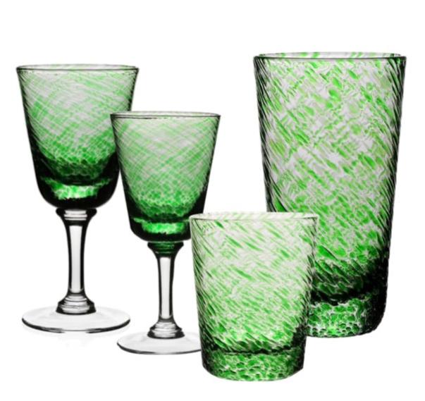 Four glass pieces from the William Yeoward Crystal Vanessa Green Collection—two stemmed wine glasses and two tumblers—are arranged on a white background, their textured surfaces creating a subtle optical illusion.