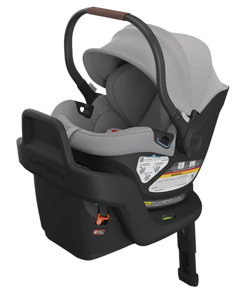 Gray UPPAbaby Aria infant car seat with base, featuring SmartSecure® technology, an extra-large canopy, a handlebar, and secure installation indicators.