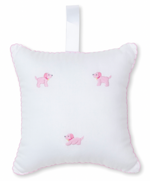 The Kissy Kissy Hand Embroidered Premier Puppies Musical Pillow w/ Tulle Bag in White/Pink features three pink embroidered puppy friends, a white ribbon loop at the top, and is adorned with pink trim.