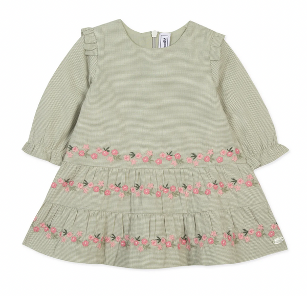 The Tartine et Chocolat Green Sage Two-Toned Gingham Floral Embroidered Dress for a baby girl features long sleeves, ruffled shoulders, and pink flower embroidery along the bottom half. The two-tone gingham pattern adds a charming touch to this adorable outfit from Tartine et Chocolat.