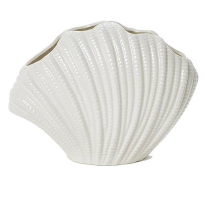 The White Shell Vase Collection by Two's Company features a glossy, ridged ceramic vase shaped like a seashell—ideal for showcasing vibrant blooms and adding coastal charm. Shown here against a plain white background.