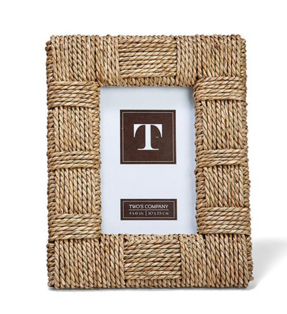 The Sea Grass Frame Collection by Two's Company features a rectangular braided frame crafted from woven wicker and sea grass rope, with a blank display area for your images and sizing details.