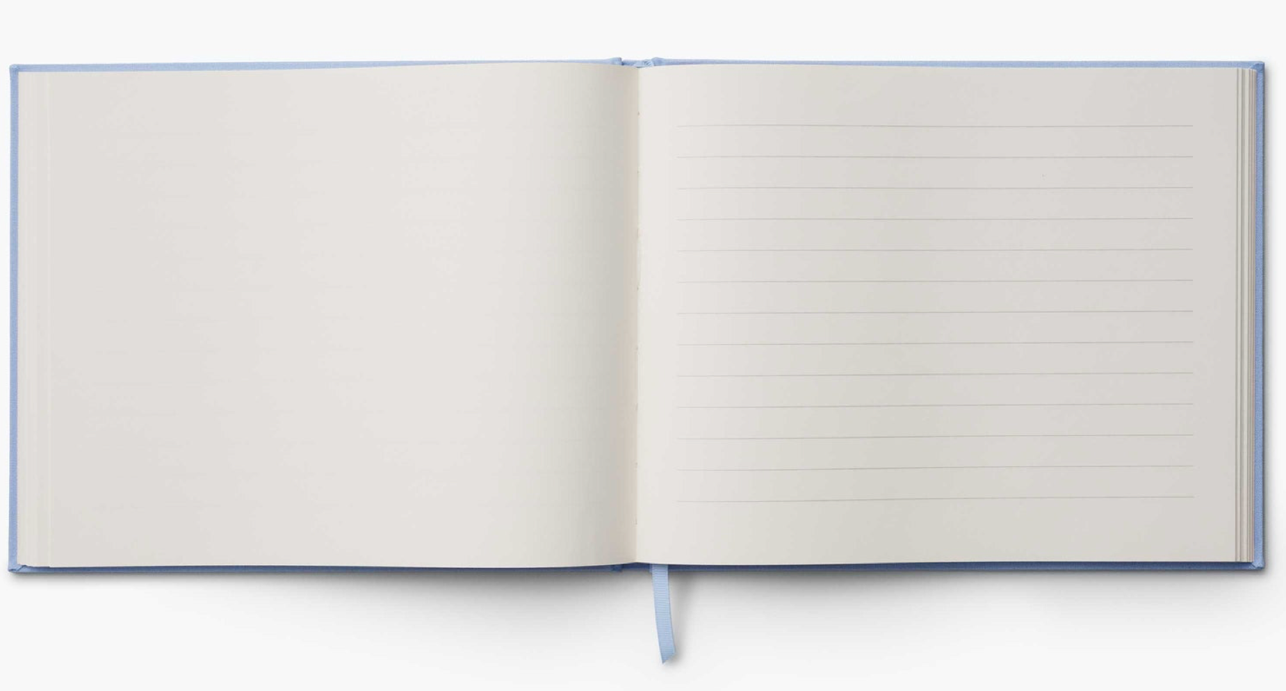 The Riffle Paper Co. Blue Hydrangea Desk Accessory Collection features an open notepad with a blank left page, lined right page, and light blue ribbon bookmark—an elegant addition to your workspace.