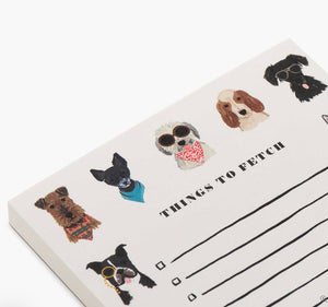 The Dog Days Notepad by Rifle Paper Co. features "THINGS TO FETCH" and cute dogs in sunglasses and bandanas, offering convenient tear-off sheets for jotting daily to-do lists.