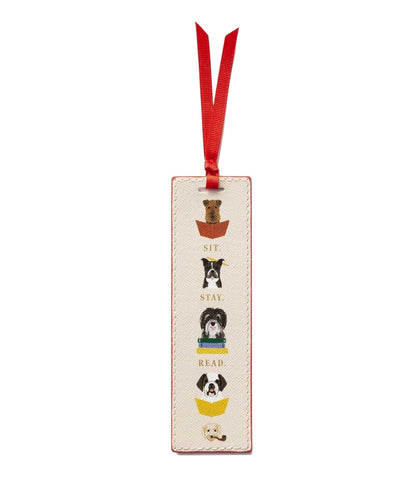 From Rifle Paper Co.'s Bookmark Collection, this cream-colored illustrated bookmark features four dogs in baskets, a red grosgrain ribbon, and the phrase "Sit. Stay. Read.