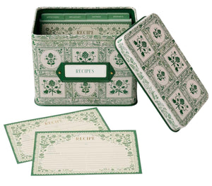 The Rifle Paper Co. Artichoke Recipe Tin is a decorative green and white metal tin with a matching lid, filled with labeled recipe cards for kitchen organization, plus two blank cards displayed in front.